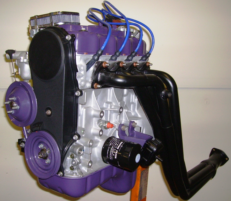 Click here for full size image.    SammyPro V  fully dressed balanced and blueprinted long block 100 to 115 horsepower comes as pictured (except distributor).  It is bored 020 030 or 040 over. It is fitted with new 10.2 to 1 hypereutectic flat top pistons, new piston pins and new Japanese chrome rings. It has rebuilt rods and crankshaft and new OEM Japanese bearings. Head is completely rebuilt. It also gets fitted with RV2 performance camshaft, new intake and exhaust valves, new OEM rocker shafts, new OEM rocker arms, new OEM rocker nuts, new OEM rocker tappets and new OEM headbolts. It comes fully dressed with oil pickup tube, oil pan, valve cover, timing belt cover, motor mount stands with new OEM motor mounts, new Nippon oil filter, new oil pressure switch and new water temperature switch.  Includes new Redline Weber performance carb, intake manifold, new premium intake studs and nuts, new premium exhaust studs with copper crush nuts, front crank and water pump pulleys water pipe tube all painted to match , new thermostat, remanufactured thermostat and distributor housings and New Pacesetter long tube header  Comes as pictured (except distributor) with new water pump, new tensioner and new OEM oil pump